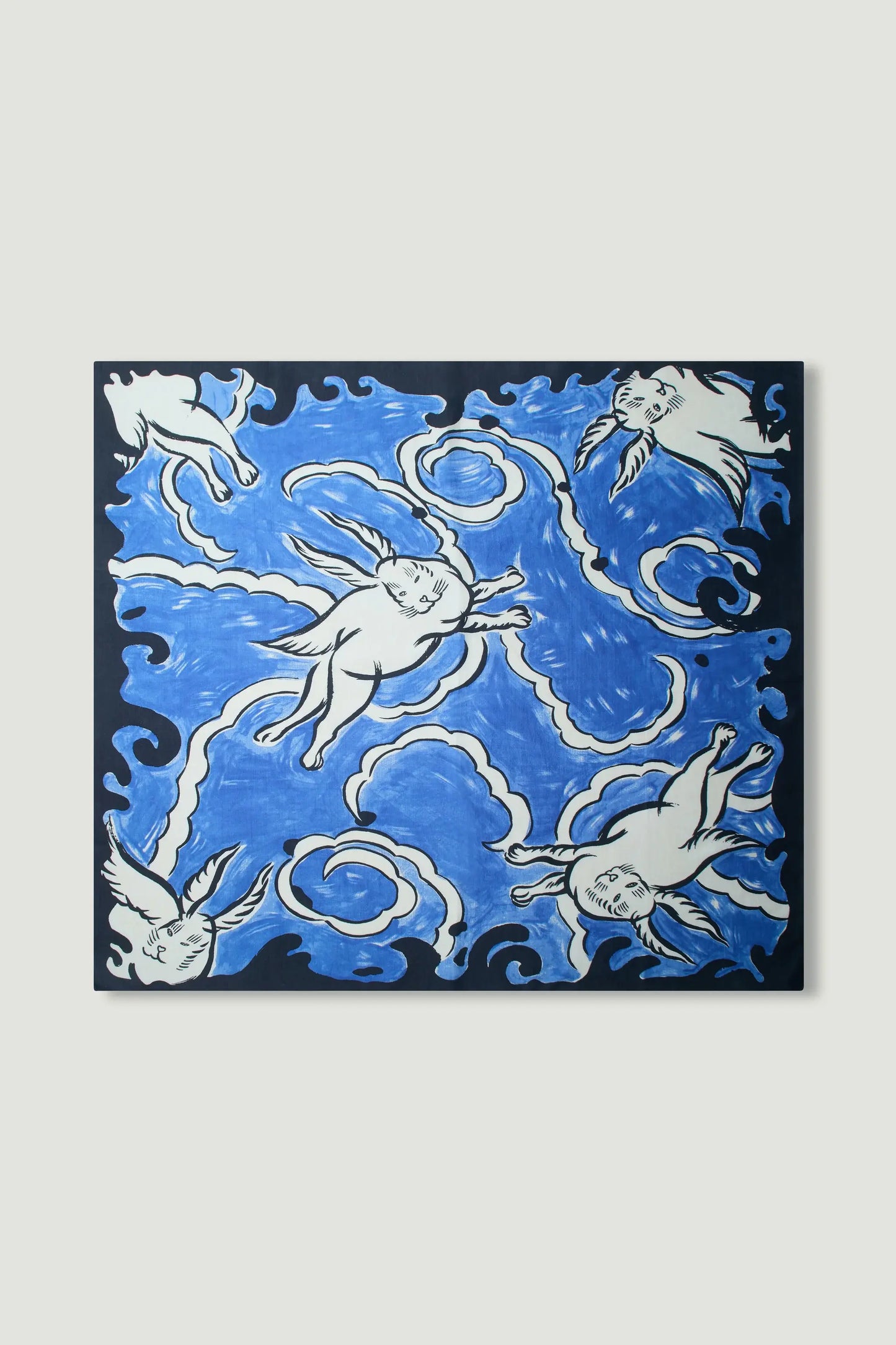 Electric blue silk scarf laid flat showing the Hero David Bowie flying white rabbits design finished with hand-rolled hem and a soft lustrous sheen. 