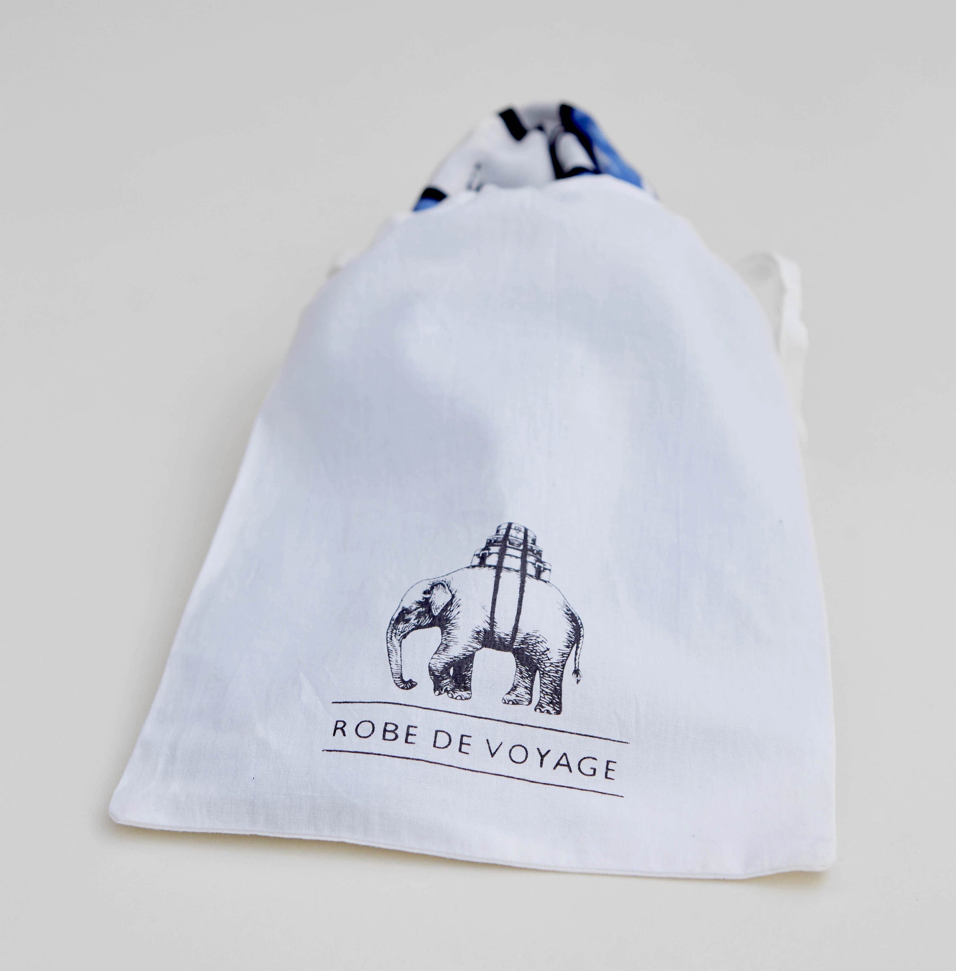 Hero David Bowie silk scarf folded inside the complimentary, Robe de Voyage cotton travel pouch with draw string and brand logo block printed on the front