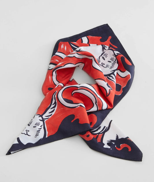 A luxury silk scarf designed for David Bowie Is exhibition featuring red, black and cream "Hero" design. The print showcases an artistic composition inspired by Bowie's Ziggy Stardust era, finished with signature hand-rolled hem and a soft lustrous sheen. 